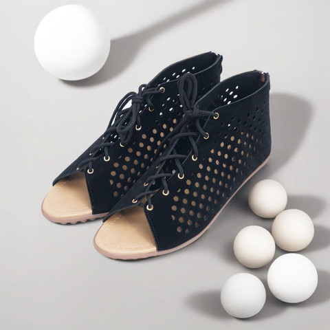 Black perforated lace-up peep-toe booties.