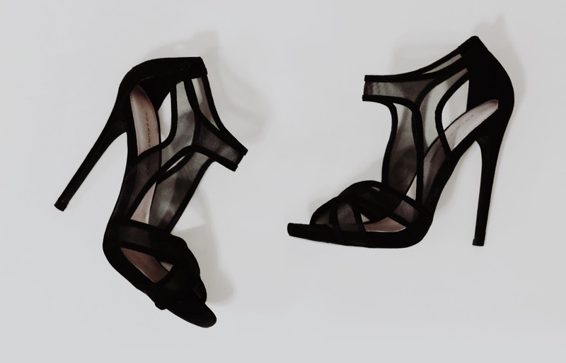 Black suede and mesh stiletto sandals.