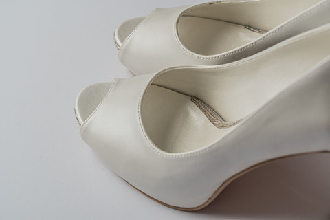Pearl peep-toe platform heels, close.