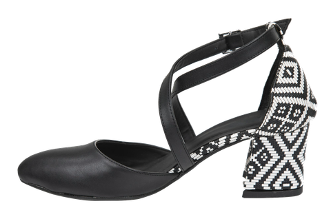 A black shoe with a woven geometric block heel.
