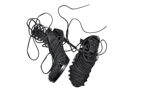 Black lace-up heels from above, the ties loose.