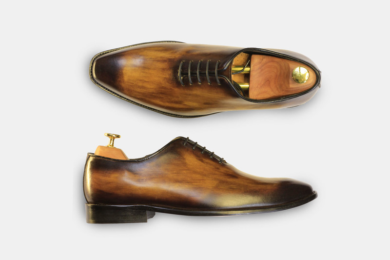 Hand-burnished wholecut oxfords with shoe trees.