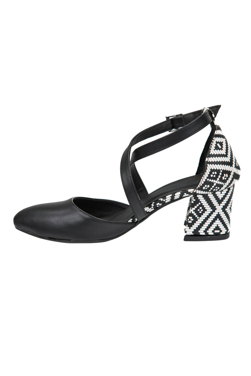 A black cross-strap shoe with a woven geometric block heel.